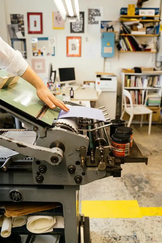 hand-of-man-working-with-printing-tools-using-machinery