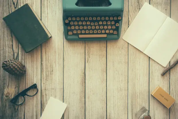 vintage-teal-typewriter-beside-book